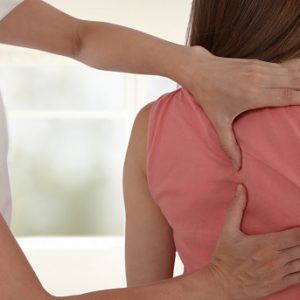 Woman having chiropractic back adjustment. Osteopathy, Physiotherapy, sport injury rehabilitation concept